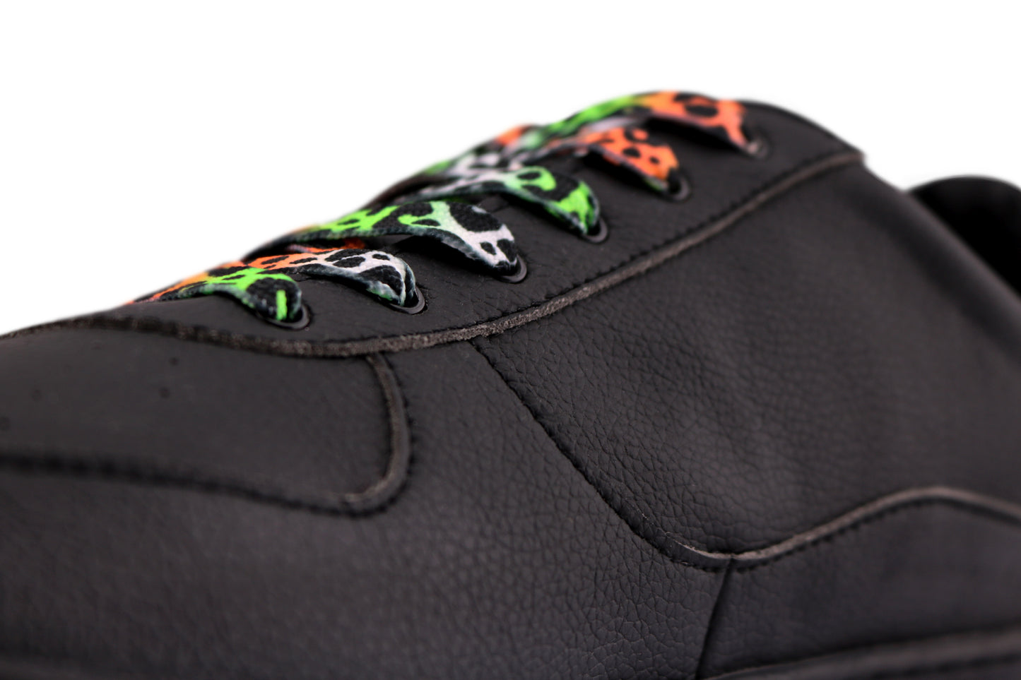 Black shoe with colorful laces on a white background
