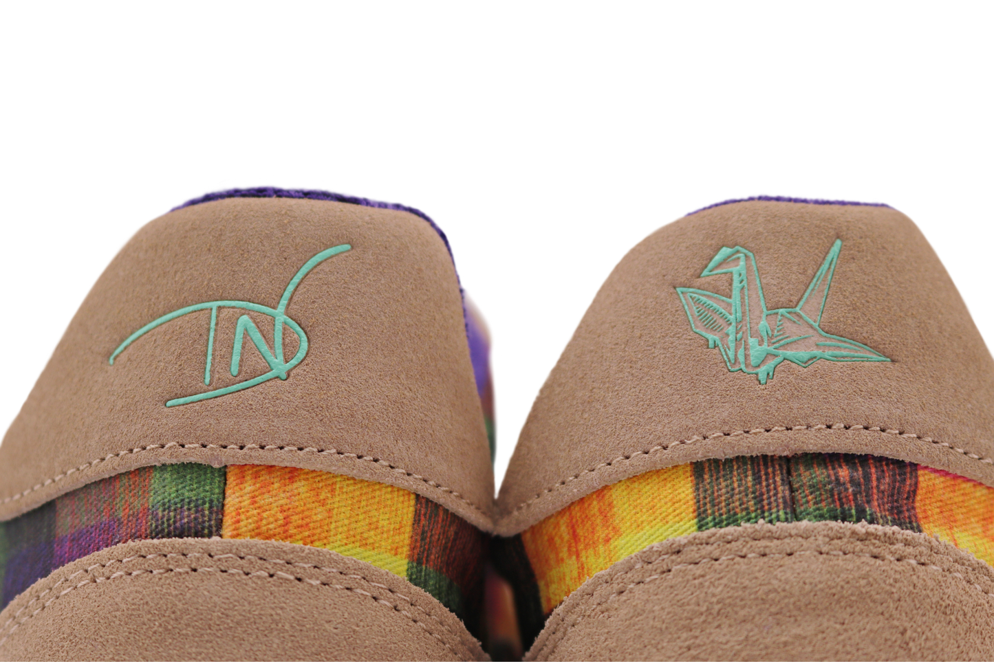 Pair of tan PaperKrane barefoot sneakers with Di Nowinski plaid pattern on a white background, the view is of the back heel panel of the shoes, with mint colour logos