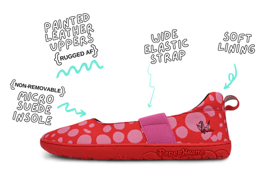 Red leather PaperKrane barefoot mary jane style shoe with bubblegum pink painted spots and pink elastic band, and red rubber soles. They're on a white background with details