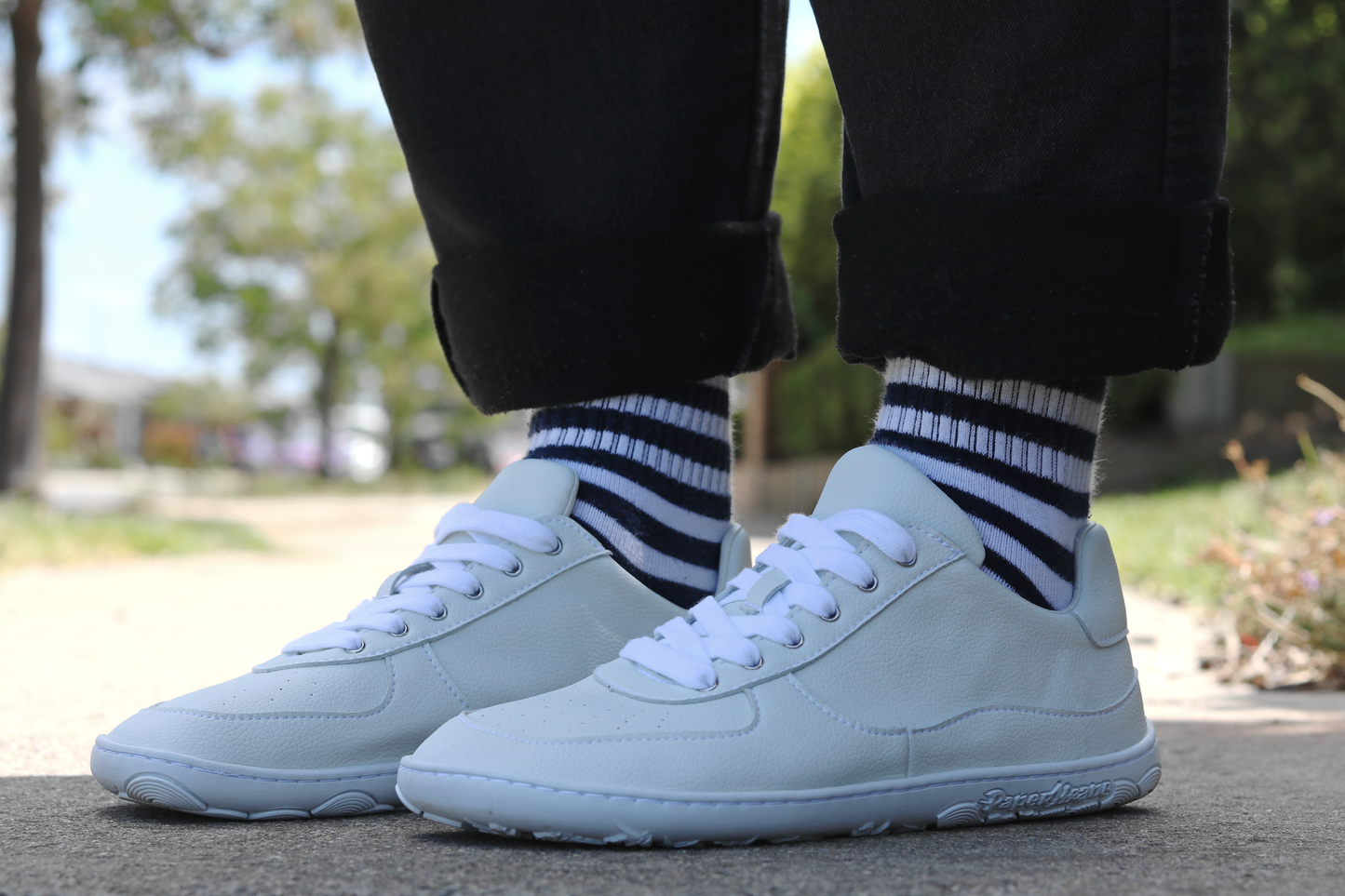 Side view of PaperKrane White Low barefoot sneakers on a person