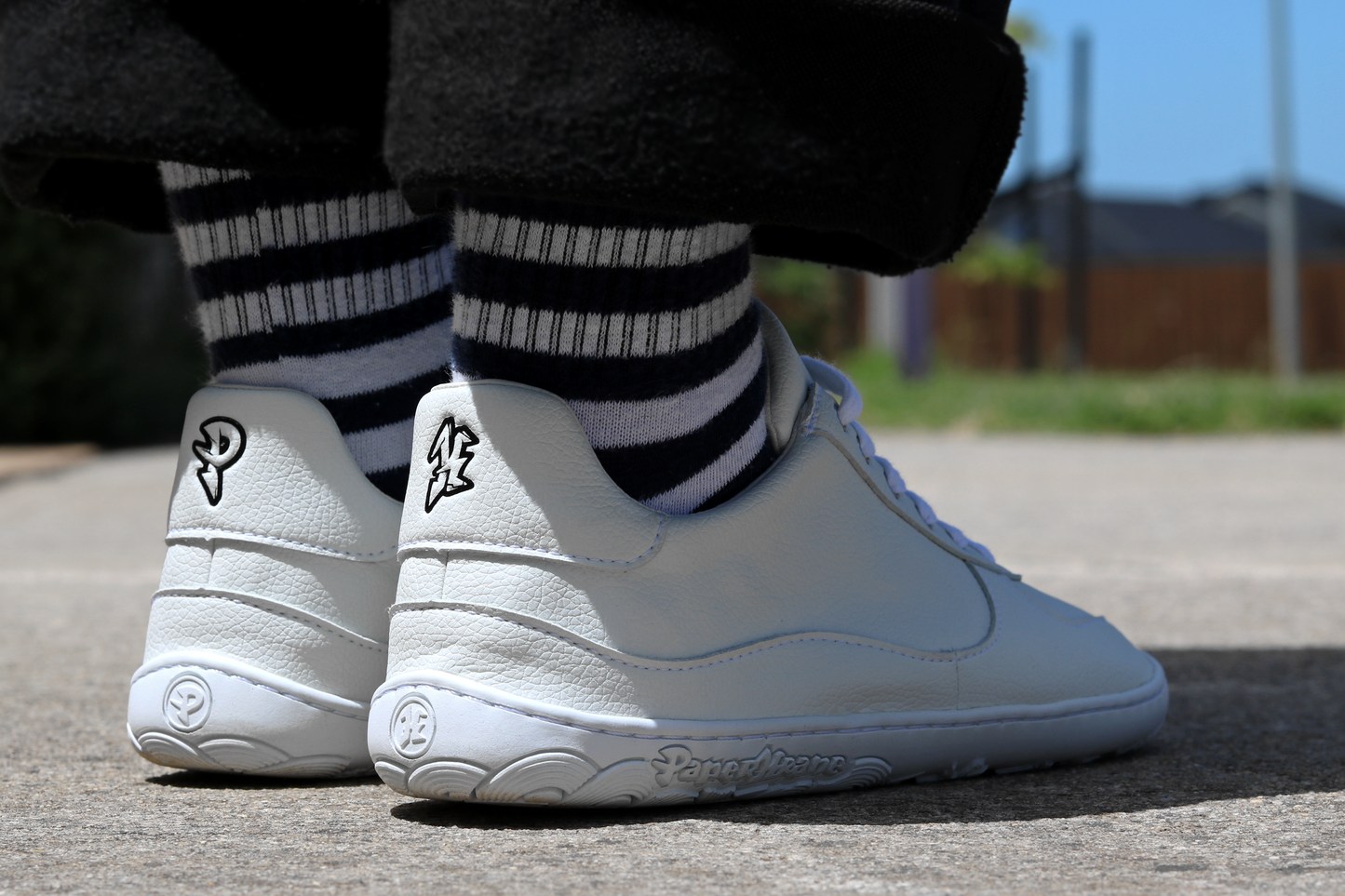 Half sun half shadow image of the back of PaperKrane white lows.