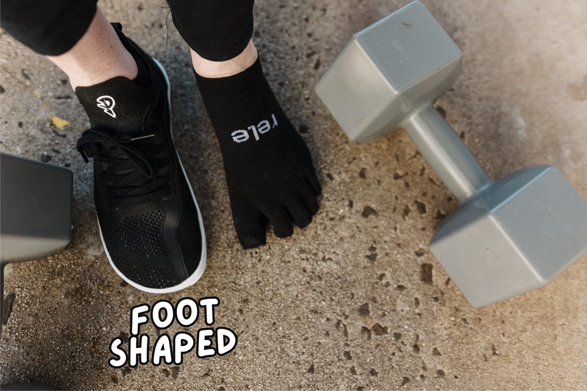 Person wearing black toe socks with PaperKrane foot-shaped shoes on a concrete surface with dumbbells.
