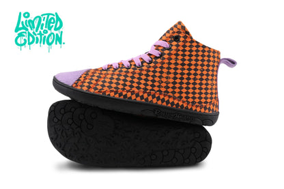 A high-top sneaker with an orange and black checkerboard pattern cotton upper, light purple corduroy toe cap and elastic laces, and a black sole, shown with its black sole resting underneath on a white background. A teal 'Limited Edition' logo is in the top-left corner.