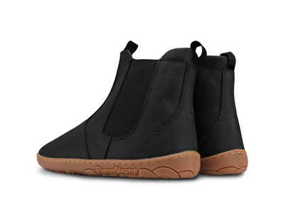 The back view of a pair of PaperKrane black leather chelsea boots on a white background. The P and K logos are embossed in the back, and also on the sole. 