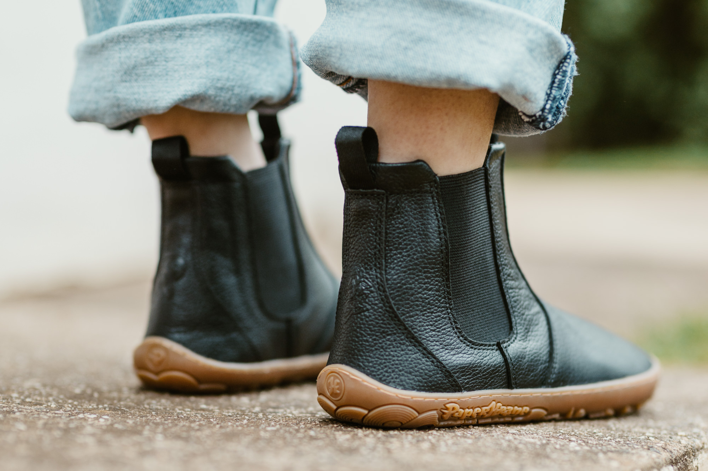 THe back of some black leather chelsea boots from Melbourne barefoot shoe brand, PaperKrane. THe black leather is soft and tumbled on a gum sole, and black elastic and loops. 