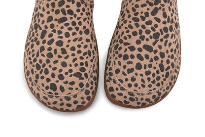 A view from above of the toe box of a pair of foot-shaped cheetah print chelsea boots from PaperKrane. The suede is beige and charcoal, with gum rubber soles on a white background.