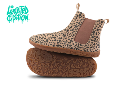 Side and sole view of a pair of PaperKrane barefoot chelsea boots. This pair is a beige suede with charcoal cheetah print, brown elastic and gum soles, on a white background with a teal "limited edition" in the top left corner. 