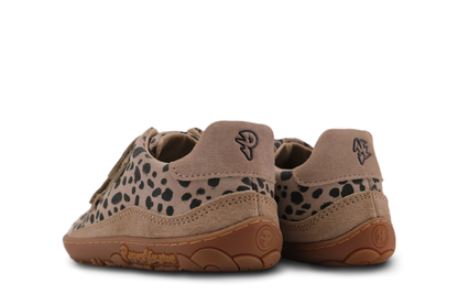 Pair of tan suede children's shoes with spotted design on a white background