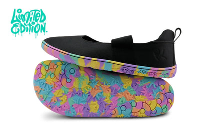 A pair of slip-on PaperKrane maryjanes shown on a white background, with one shoe resting on top of the other. The upper is black, and the sole features a colorful abstract pattern in pink, purple, blue, yellow, and green. They're "Limited Edition".