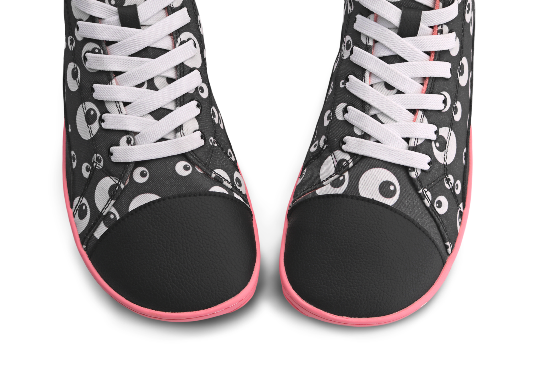 Above view of the toebox of a pair of foot-shaped PaperKrane boots. They're a vegan pair with a black toe cap, and a cartoon eyeball print on cotton. The elastic laces are white, and the shoes are on a white background. 