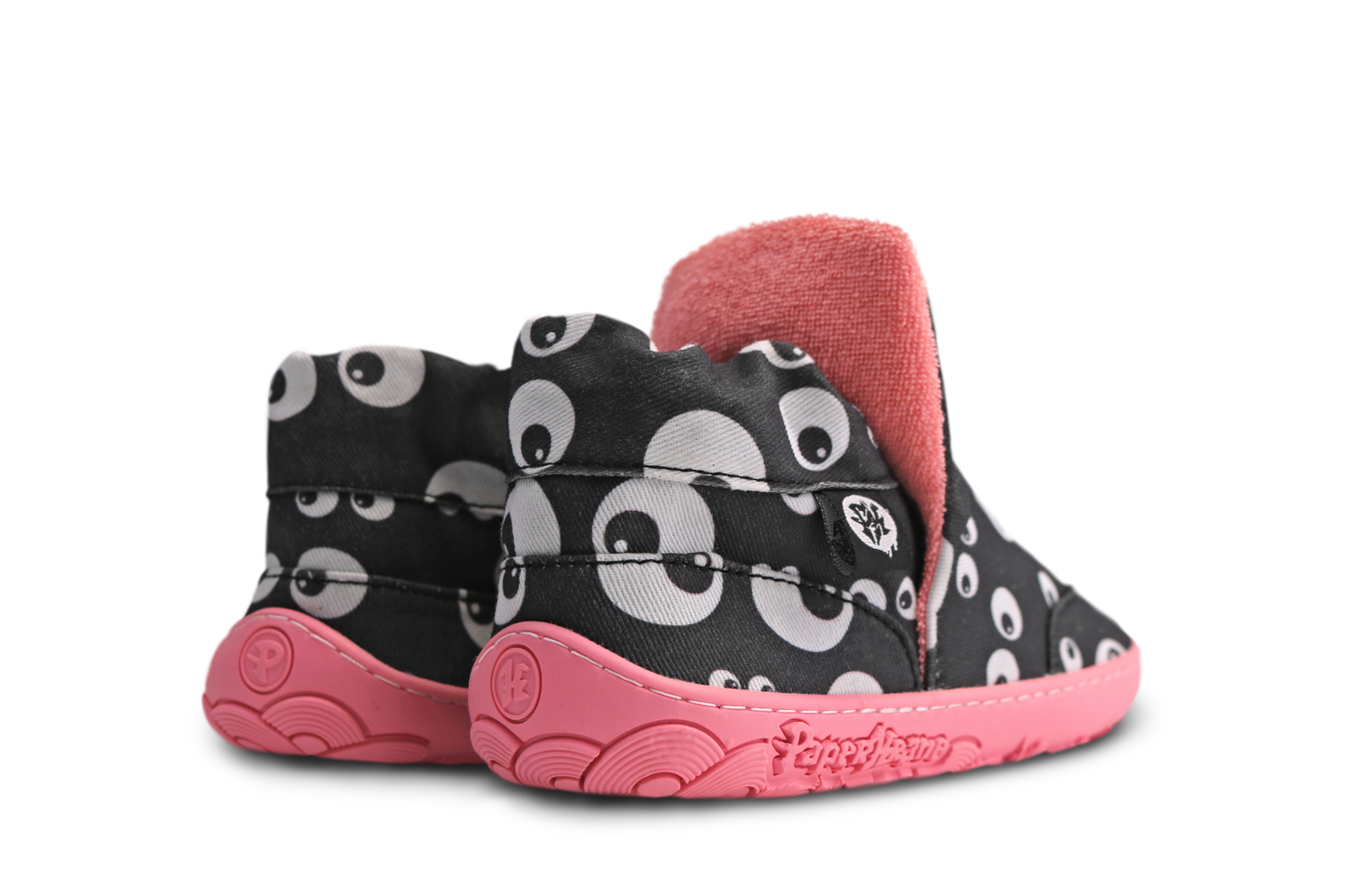 Back view of PaperKrane signature slip on high tops for the kids. The salmon coloured terry cotton lining and sole are matching, and they pop against the black cotton with cartoon eyeballs printed on it. The shoes are on a white background. 