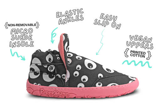 Side view of one Eyeball Signature slip on shoe. These flat and flexible shoes are perfect for kids, you can see the cartoon eyeball print, and salmon sole and lining of this pair. The image is on a white background with product details around it. 