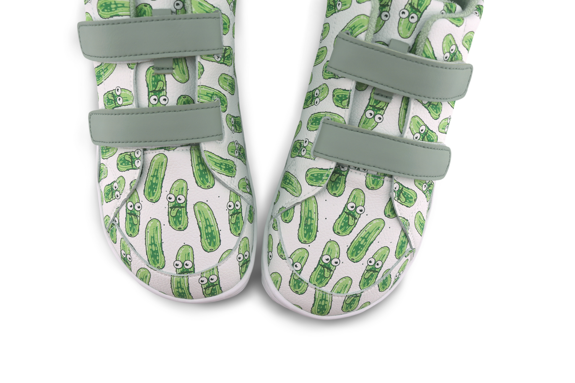 Pair of velcro shoes with green pickle pattern on a white background