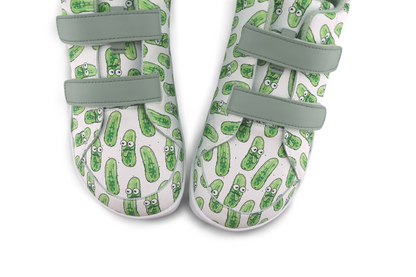 Pair of velcro shoes with green pickle pattern on a white background