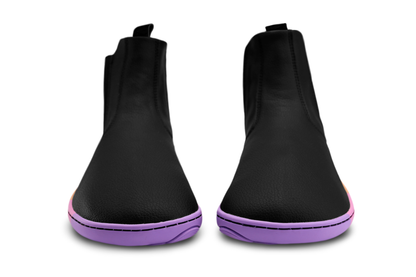 Black vegan leather chelsea boots from the front with wide toe box by PaperKrane, they have a rainbow sole on a white background. 