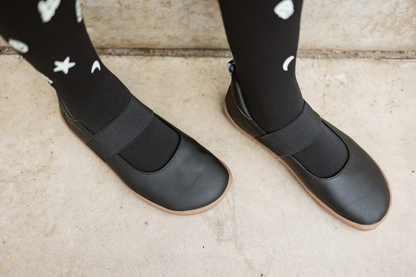 Angled above view of black vegan mjs on a gum sole, on concrete