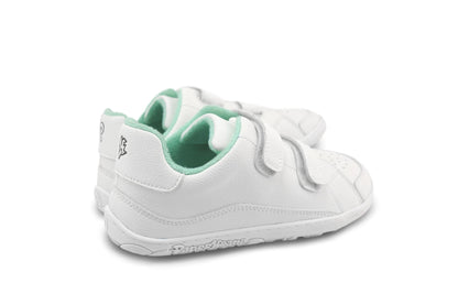 A pair of white children's barefoot PaperKrane sneakers with mint green terry cotton interior lining and hook-and-loop velcro strap closures, shown from a side-rear angle on a white background.