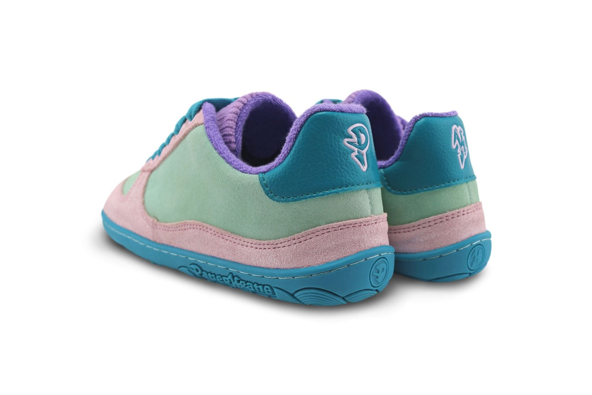 A pair of pastel-colored leather/suede sneakers shown from a rear angle on a white background. The shoes feature mint green suede panels, glittery light pink suede overlays, a teal rubber sole, and a purple interior lining and tongue.