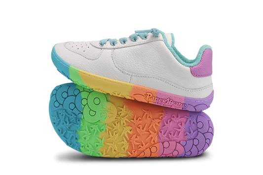 White sneaker with foot-shaped rainbow sole on a white background