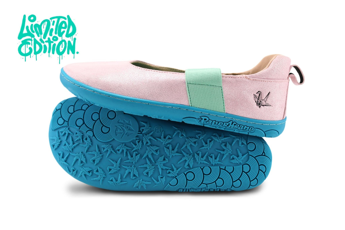 A pair of Mary Jane style shoes in shimmery pastel pink leather with a mint green elastic strap, shown with a bright teal textured sole. The brand name 'PaperKrane' is embossed on the side of the sole, and a 'Limited Edition' logo is visible in the top left corner.