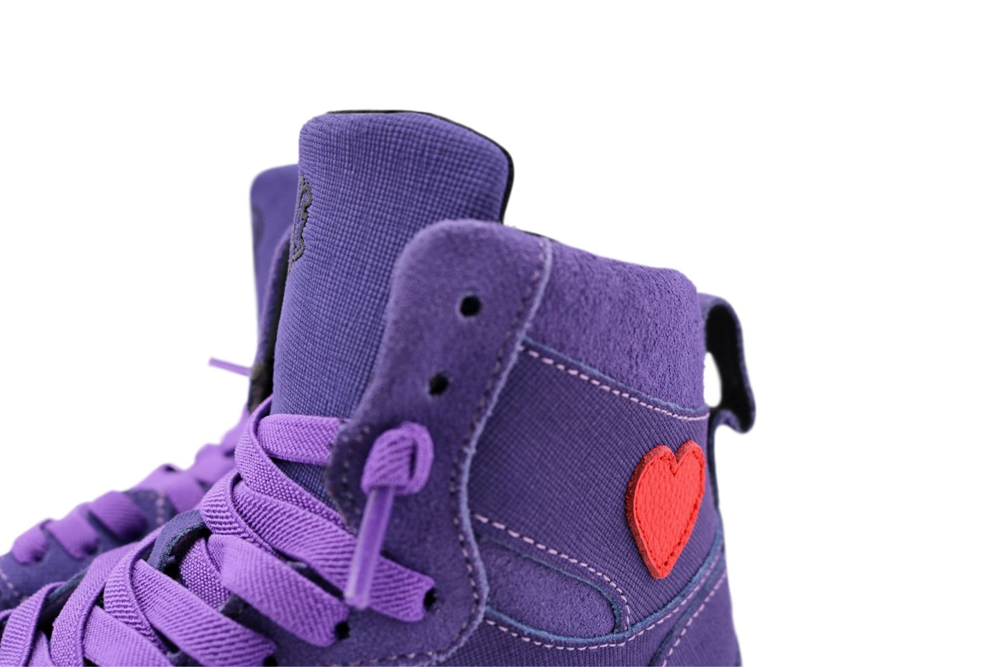 Purple high-top sneakers with a red heart on a white background