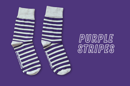 Pair of Roam Barefoot New Zealand made merino socks with purple and beige/grey stripes on a purple background