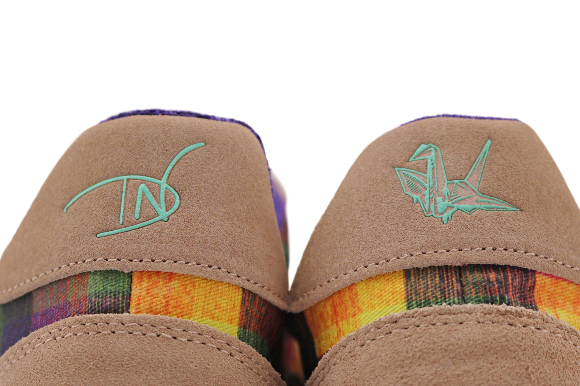 Pair of tan PaperKrane barefoot sneakers with Di Nowinski plaid pattern on a white background, the view is of the back heel panel of the shoes, with mint colour logos