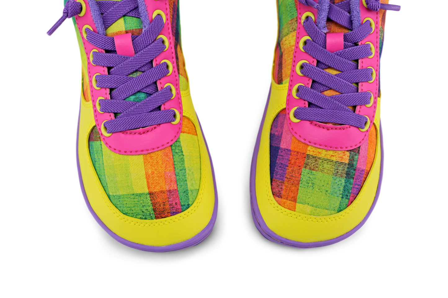 Colourful sneakers viewed from above with multicolored plaid pattern by artist Di Nowinski, and bright purple elastic laces on a white background