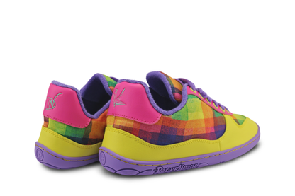 Colourful checkered shoes with pink, yellow, and purple accents on a white background. These barefoot shoes feature an art print by Di Nowinski. Logos on the back heel of the shoes are mint colour. 