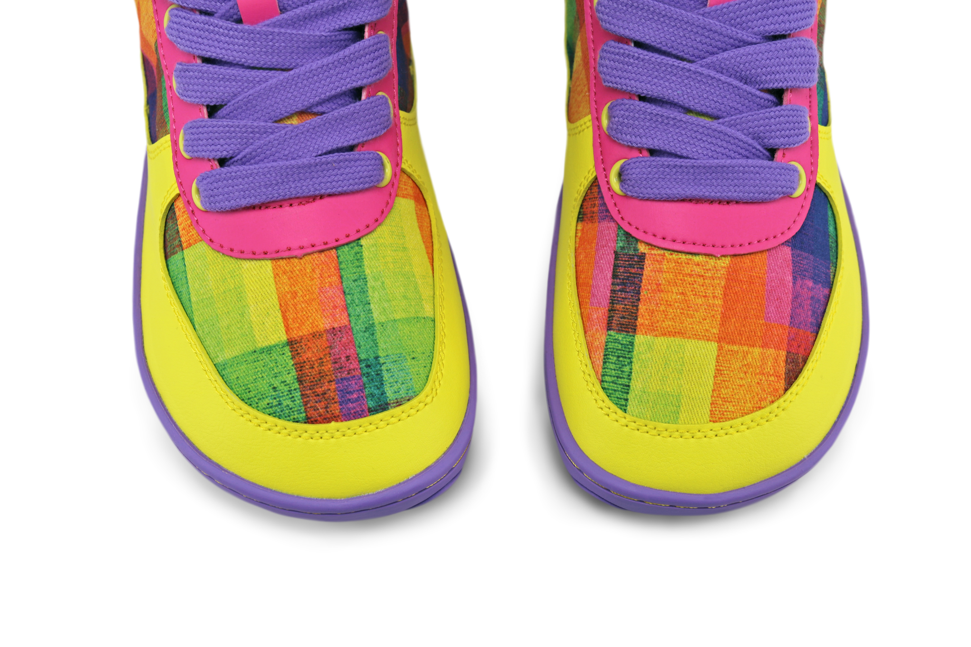 Colourful foot-shaped toe box of PaperKrane x Di Nowinski collab sneakers. The shoes are very colourful, yellow, purple, hot pink, with plaid print by Di Nowinski, they're vegan materials. 