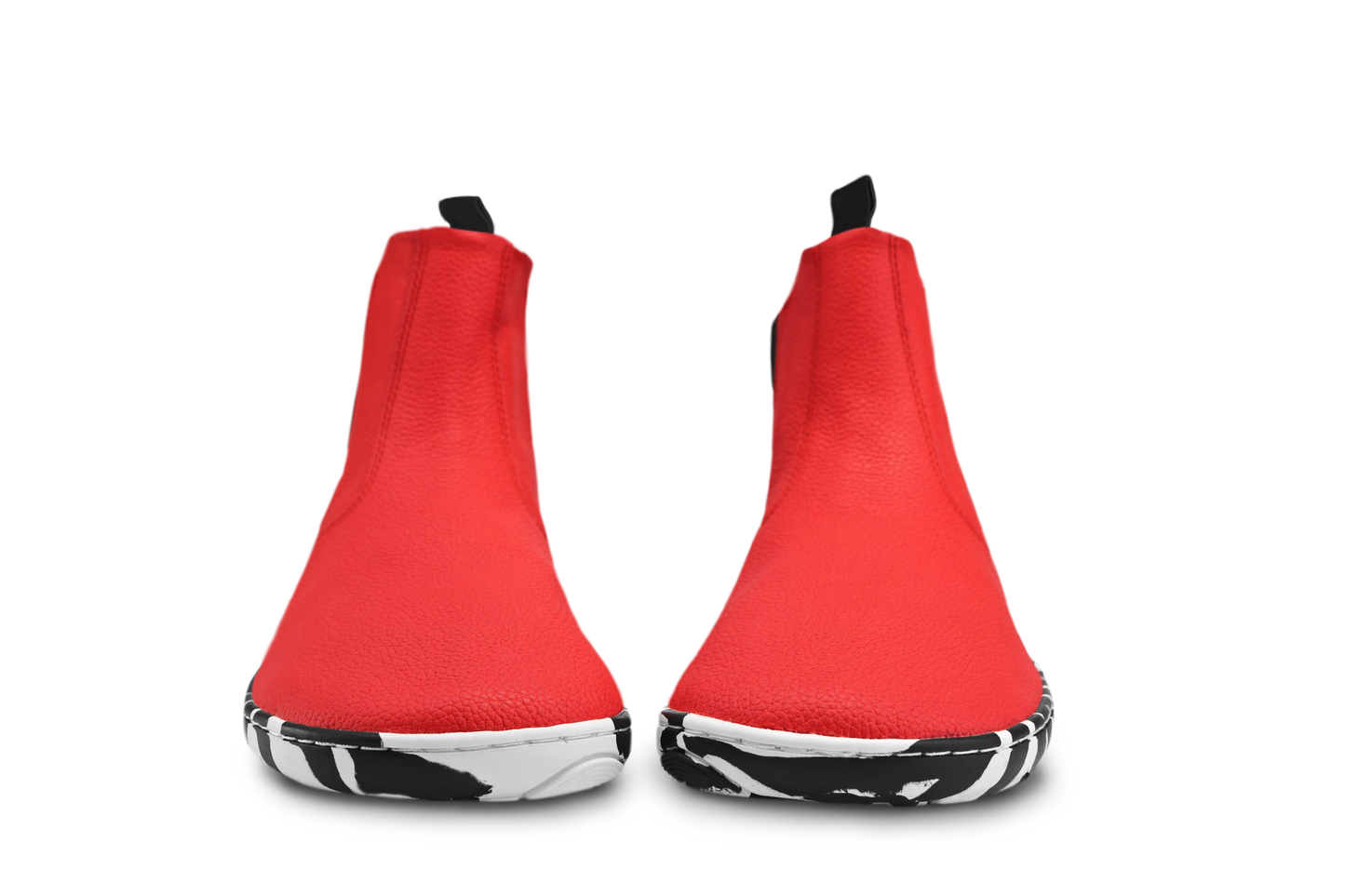 Red leather PaperKrane barefoot chelsea boots with a zebra print rubber sole, viewed from the front to show the wide toe box shape. 
