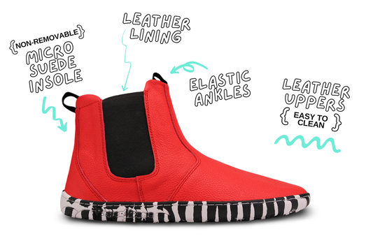 Red leather PaperKrane barefoot chelsea boots with a zebra print rubber sole. Side view of one boot with product details on a white background. 