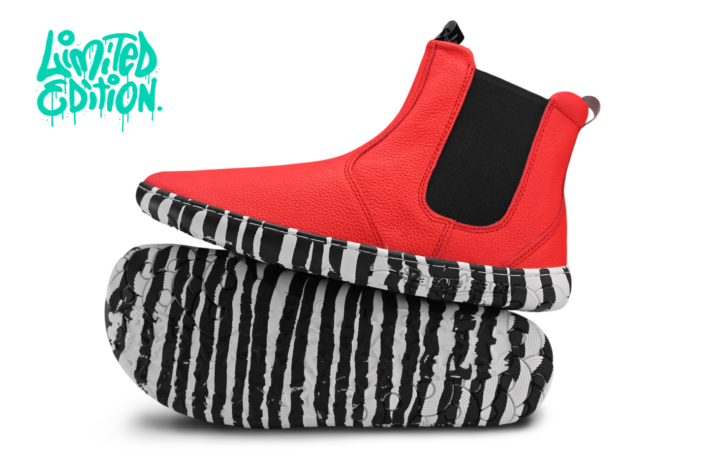 Red leather PaperKrane barefoot chelsea boots with a zebra print rubber sole. On a white background with a teal "limited edition" in the top left corner. 