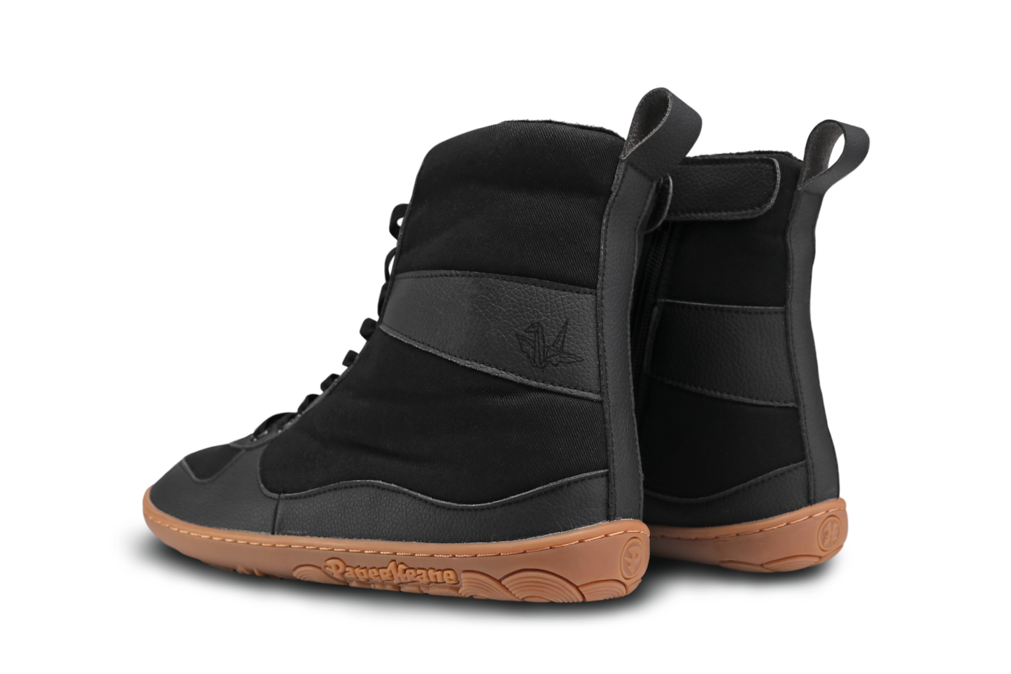 PaperKrane SNUGG boots on a white background. The boots are vegan-friendly with cotton and vegan leather details. A krane logo is embossed on the side panel. The gum sole is a great match with the black uppers. 