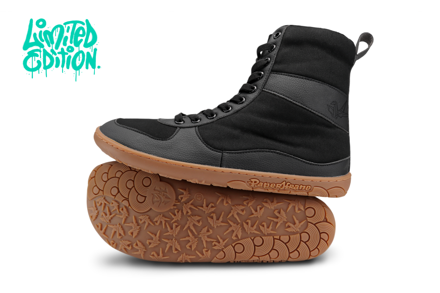 PAPERKRANE VEGAN FRIENDLY BAREFOOT "SNUGG" BOOTS, THEY'RE BLACK ON A GUM SOLE WITH ELASTIC LACES ON A WHITE BACKGROUND WITH "LIMITED EDITION" IN THE TOP LEFT CORNER. 