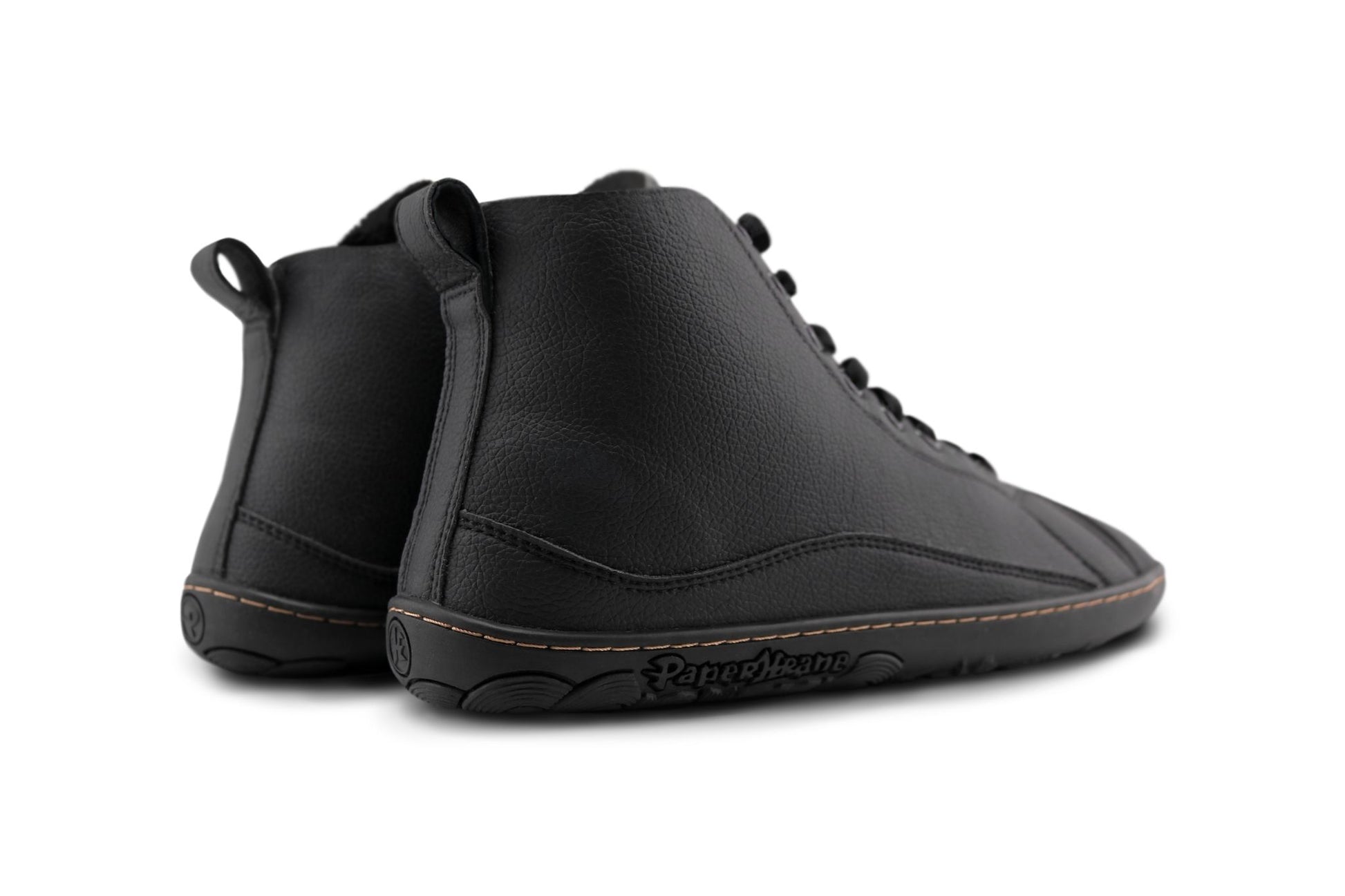A pair of black vegan leather high-top lace-up shoes with a black barefoot sole, shown from a back angle on a white background.