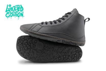 A pair of black vegan leather high-top sneakers, with one shoe standing upright and the other lying on its side to show the treaded sole. The brand name 'PaperKrane' is visible on the side of the sole. There is a teal "Limited Edition" written up in the top left corner. 