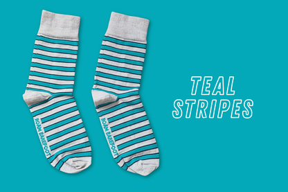 Pair of Roam Barefoot New Zealand made merino socks with teal and beige/grey stripes on a teal background