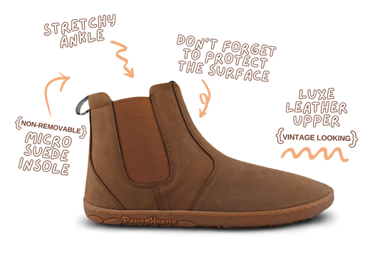 Brown leather barefoot chelsea boot with features highlighted on a white background
