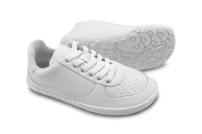 White sneakers with elastic laces on a white background