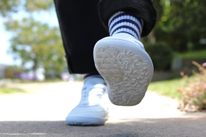 Toe up close on a pair of PaperKrane white low barefoot sneakers 