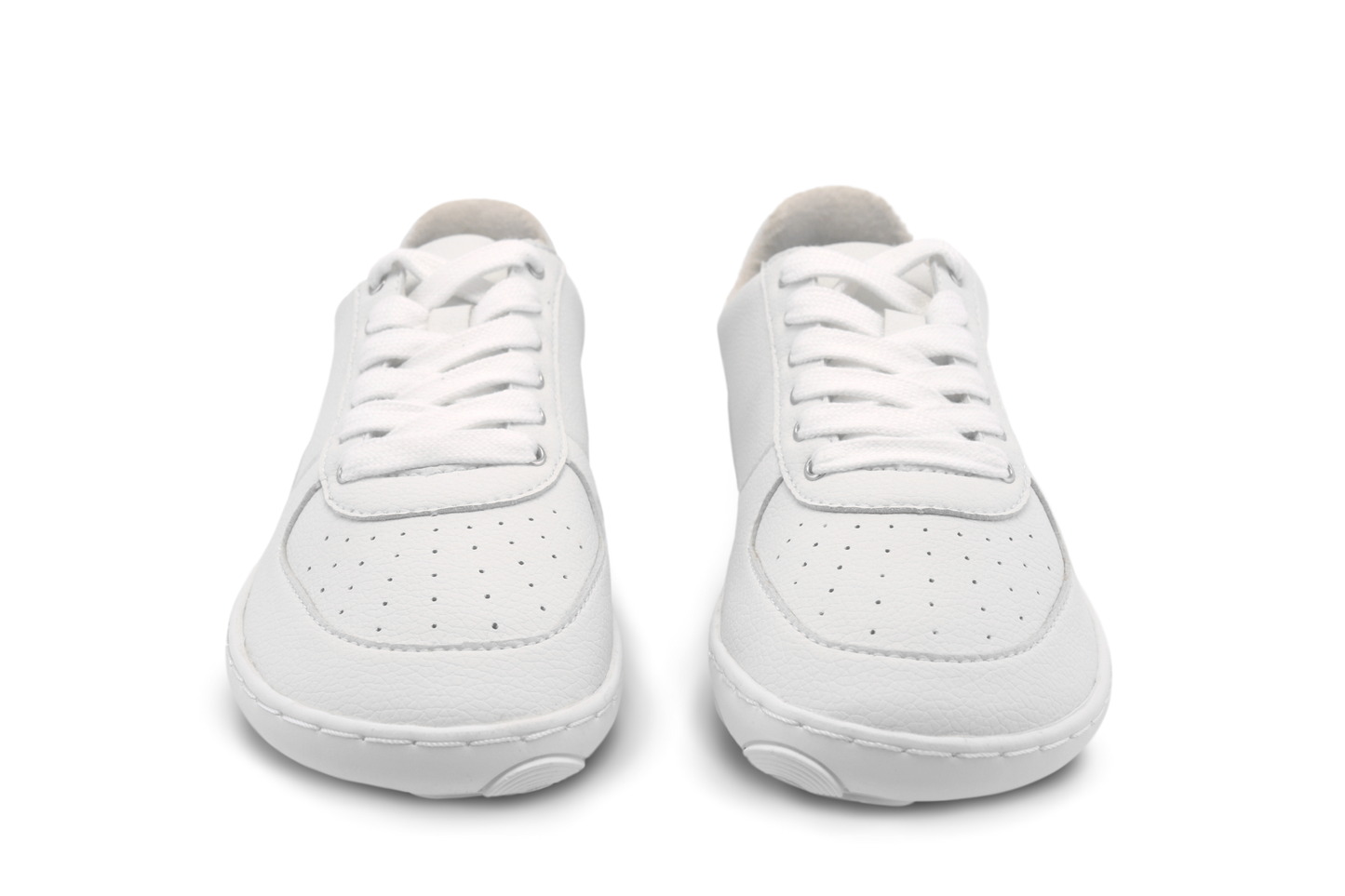 Pair of white wide toe box sneakers on a white background