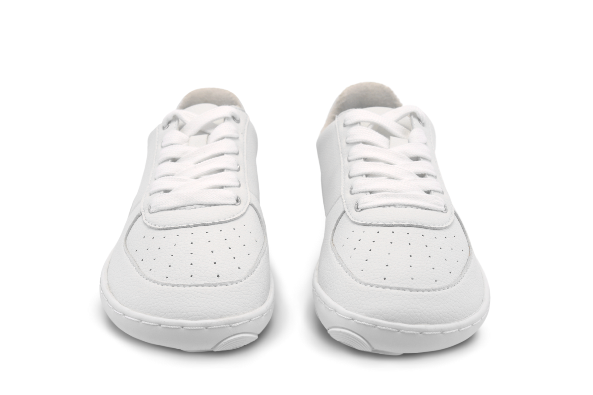 Pair of white wide toe box sneakers on a white background