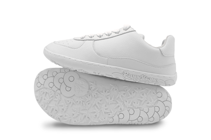 White sneakers with soles facing up on a white background